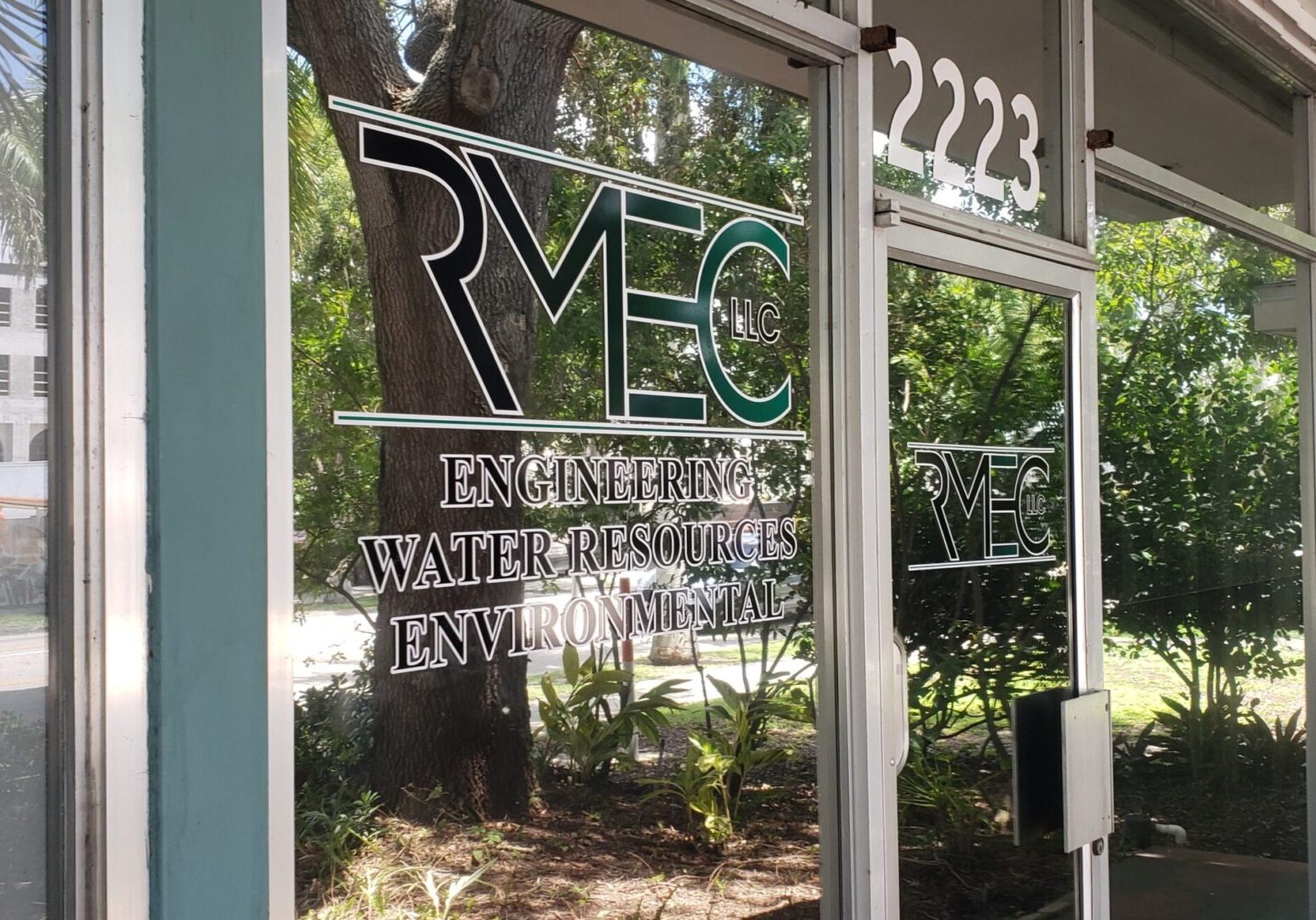 a glass door with the RMEC, LLC logo